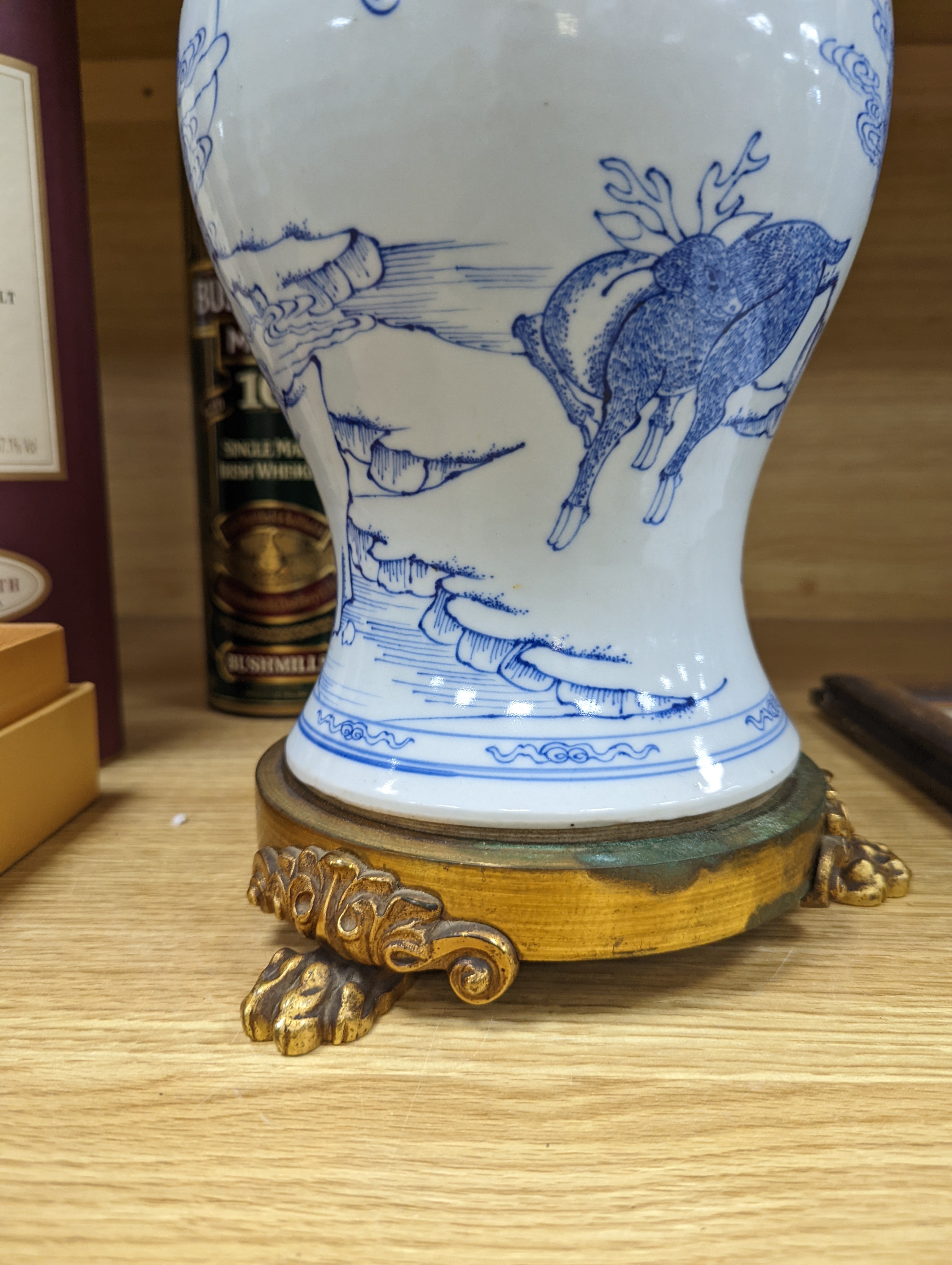 A Chinese blue and white baluster vase, brass mounted 29cm